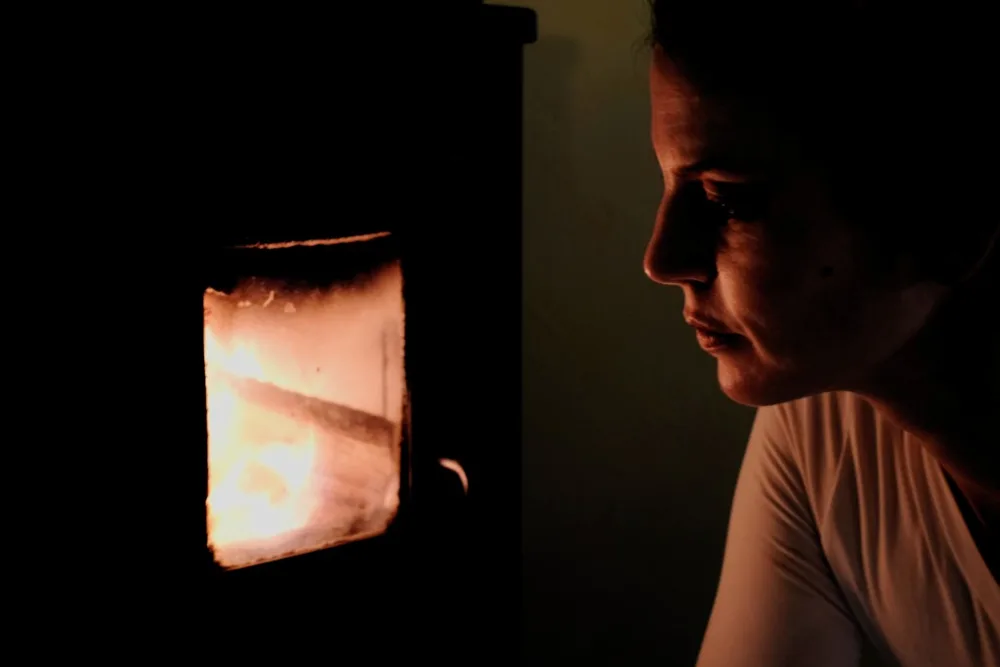 Ritratto di una donna nella luce calda di una stufa